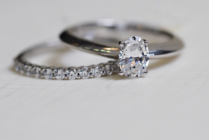 Claw set diamond wedding ring & Oval diamond solitaire engagement ring